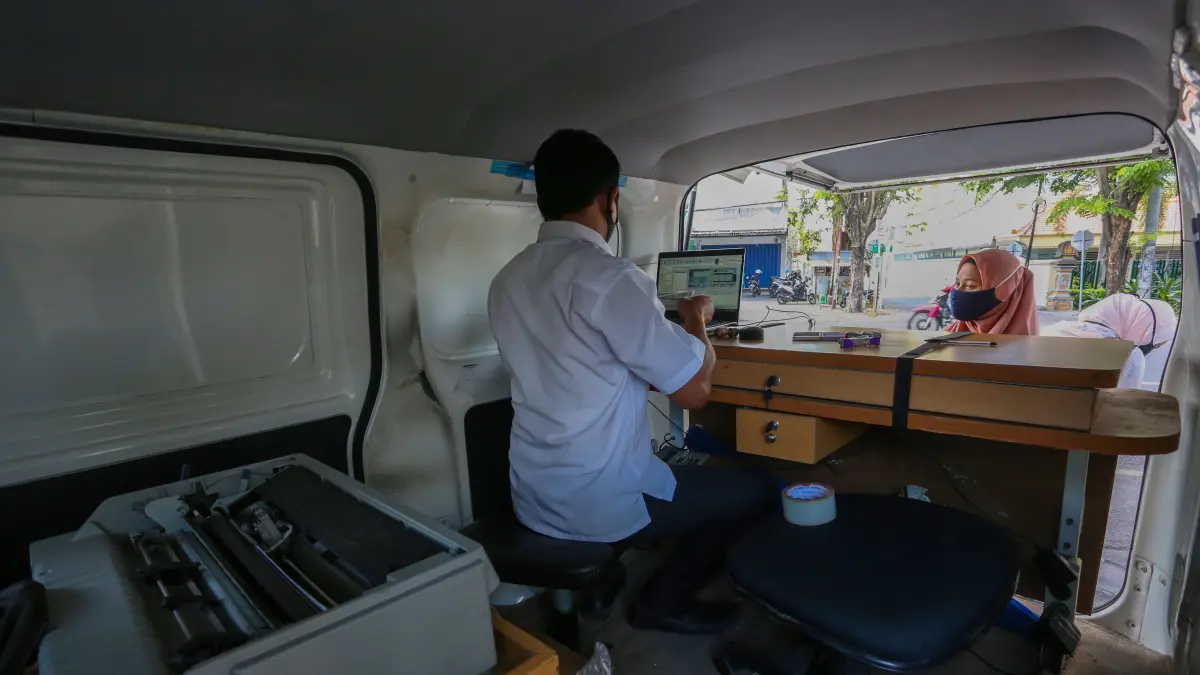SUMBER PAD: Petugas melayani seorang warga yang membayar Pajak Kendaraan Bermotor (PKB), di layanan Samsat depan Kantor Bapenda NTB, beberapa waktu lalu. (IVAN/LOMBOK POST)