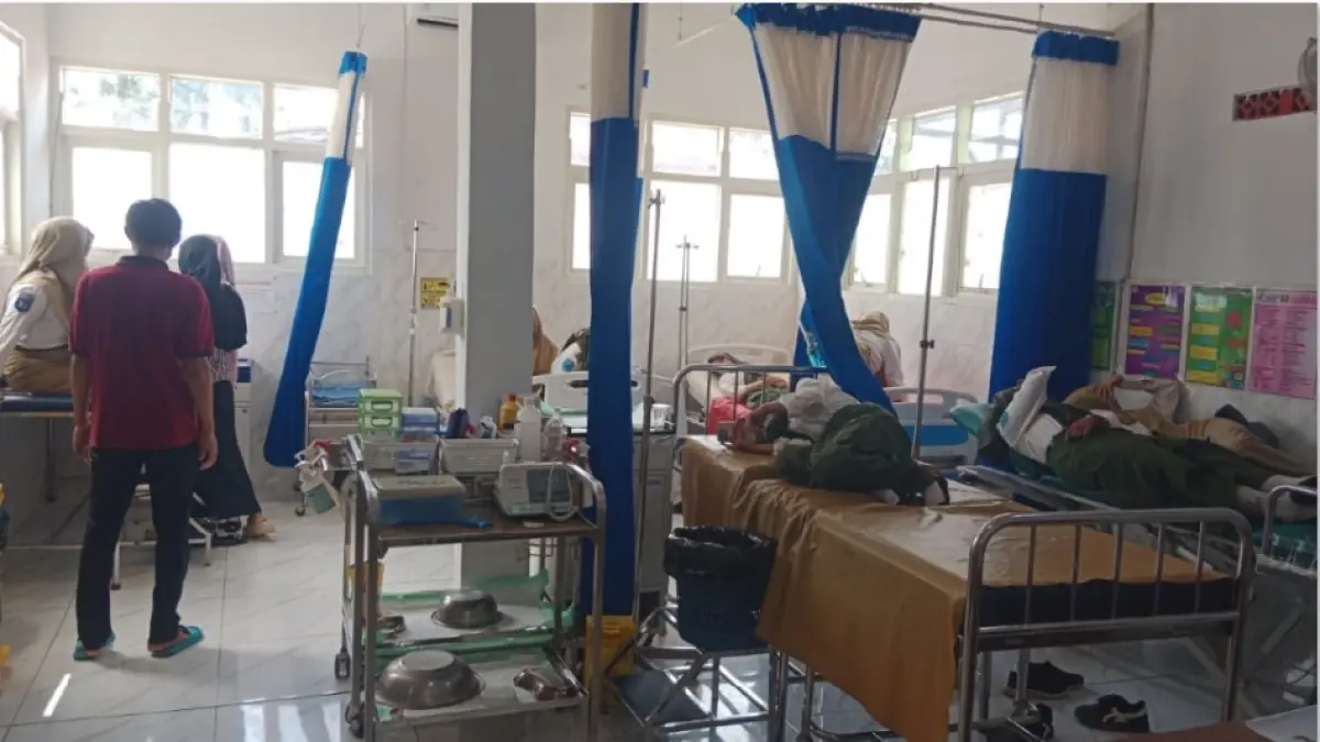 MUAL MUNTAH: Pimpinan tim MBG Bangkalan menjenguk siswa yang dirawat di Puskesmas Kokop pada Kamis (4/6) malam. (RADAR MADURA GRUP JAWA POS)