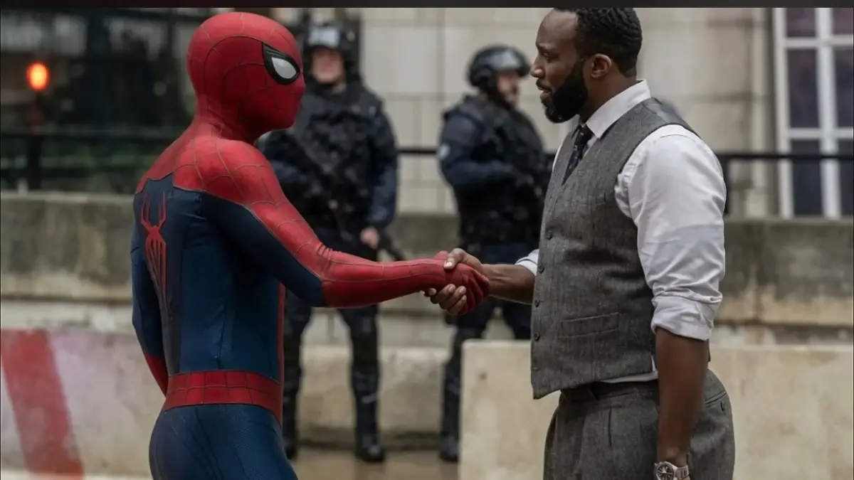Will Metzger berjabat tangan dengan Spider-Man.