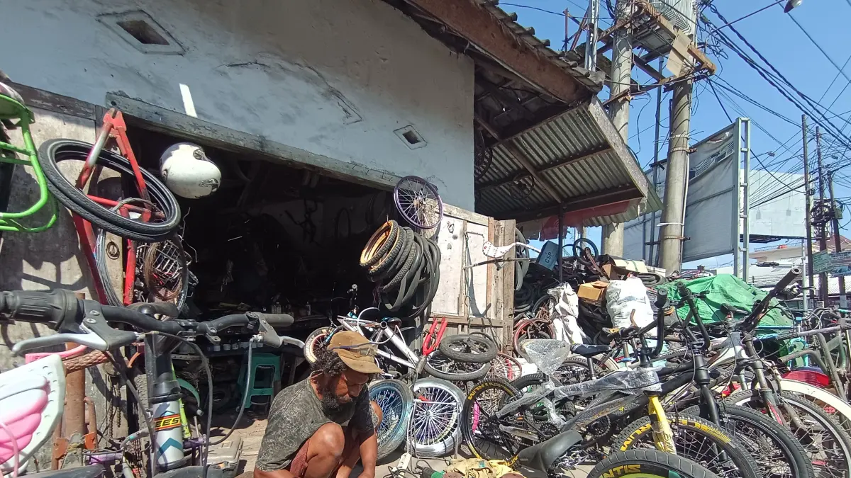 BENGKEL TUA: Naofal Hayaza memperbaiki sepada bekas di bengkel Mercusuar miliknya, Selasa (7/7).

&nbsp;