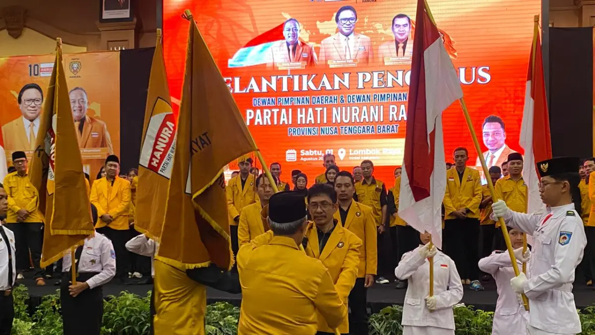 KIBARKAN BENDERA: Ahmad Dahlan mengibarkan Bendera Partai Hanura usai dilantik menjadi Ketua DPD Hanura NTB belum lama ini. (Foto: Toni/Lombok Post)