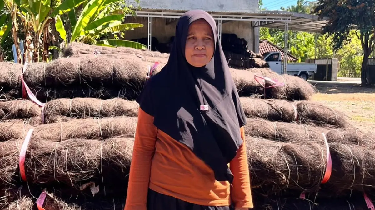 Seorang pekerja berpose di balik tumpukan ijuk yang berhasil diproduksi masyarakat Desa Beru, Kecamatan Jereweh. Ijuk ini menjadi salah satu faktor pendukung kesukseskan reklamasi AMMAN di area tambang Batu Hijau, Kecamatan Sekongkang.(Faruk/Lombok Post)