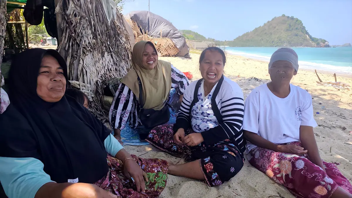 Baiq Humaiyah (dua kiri) bersama keluarganya bersantai di tepi Pantai Kuta Mandalika, Desa Kuta, Pujut, Loteng, Senin (31/8) lalu. Keluarga ini satu dari banyaknya keluarga lain yang menginap di pesisir pantai menjalani tradisi Madak Mare. 
