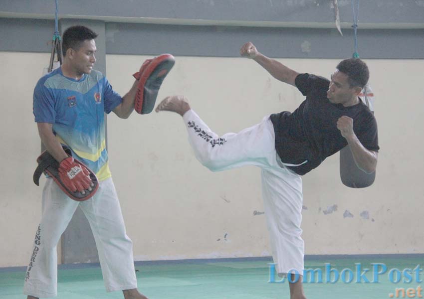GAGAL DI KEJURNAS: Atlet tarung derajat NTB M Yamin (kiri) menahan tendangan Murdani saat latihan di Padepokan GOR 17 Desember Mataram, Jumat (22/2) lalu.