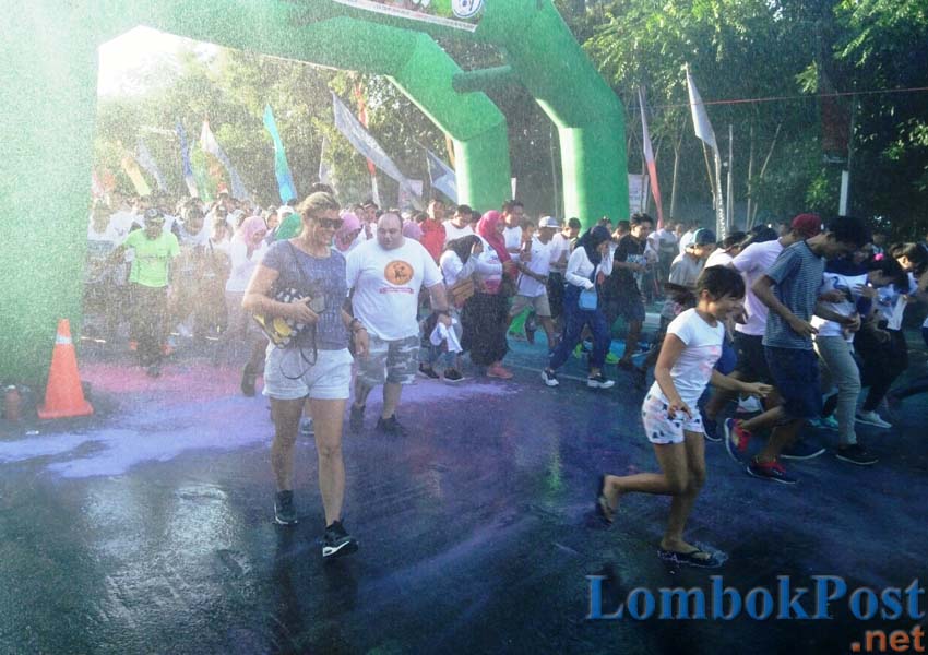 MULAI KEMBALI: Sejumlah wisatawan asing yang sedang berlibur di Senggigi mengikuti kegiatan Colour Run yang menjadi rangkaian HUT Lobar ke-61 kemarin (10/3).