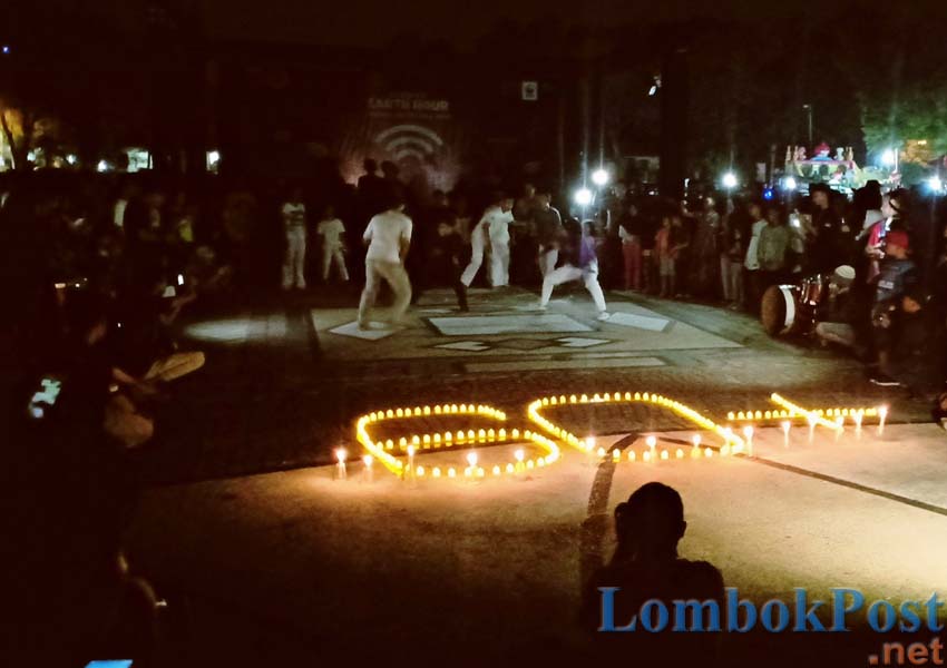 DEMI BUMI: Sejumlah komunitas pecinta lingkungan beratraksi saat acara Earth Hour atau Jam Bumi di Lapangan Sangkareang, Kota Mataram Sabtu malam (30/3).