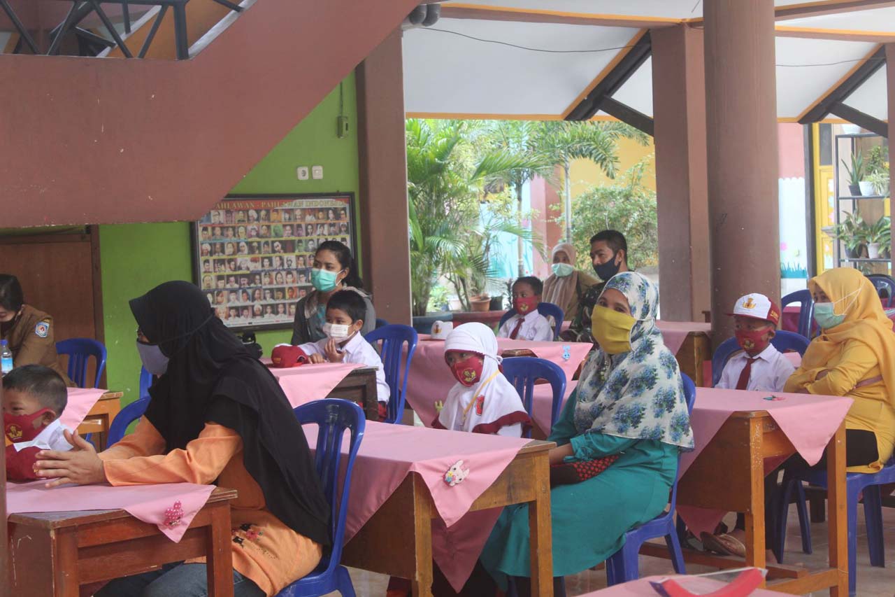 SIMAK PENGARAHAN: Para murid baru SDN 7 Mataram dan orang tua, menyimak materi dalam MPLS tatap muka, di sekolah, Senin (20/7/2020).