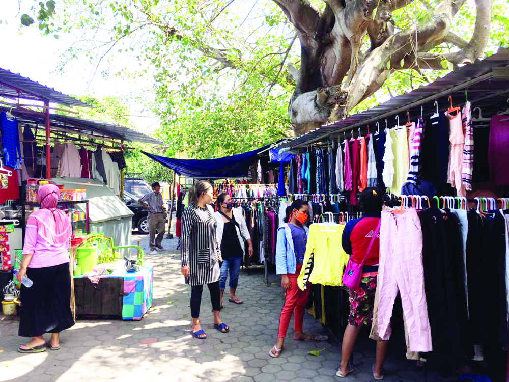 BERBURU BAJU BEKAS : Sejumlah pembeli mengunjungi salah satu lapak pedagang baju  bekas, di Pasar Karang Sukun, Jumat (24/7/2020).