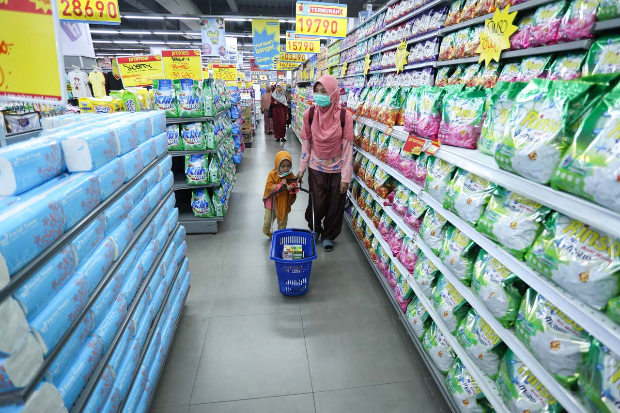 TUTUP SEBELUM JAM 10 MALAM: Seorang ibu rumah tangga berbelanja bersama anaknya sambil mengenakan masker di salah satu pusat perbelanjaan di Kota Mataram, Selasa (19/1/2021)