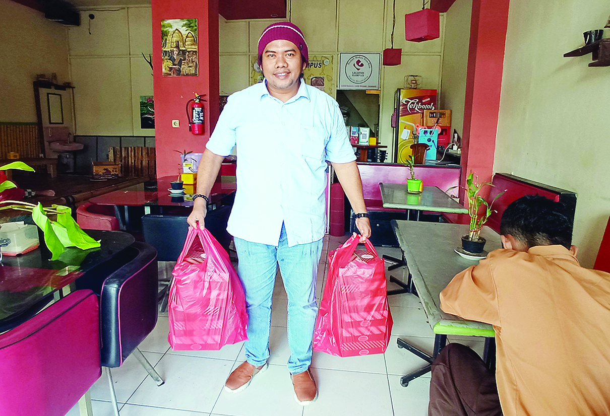 PANTANG MENYERAH: Cak Fadil, owner Lalapan Kampus hendak mengantar pesanan pelanggannya, Sabtu (6/3/2021) lalu.  (Toni/Lombok Post)