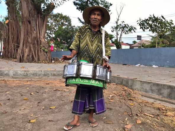 MASIH BERTAHAN: H Muhamad Sahdan, pedagang gula gending asal Desa Kembang Kerang Daya, Kecamatan Aikmel berjualan di Taman Rinjani Selong, kemarin (12/10).( Fatih/Lombok Post)
