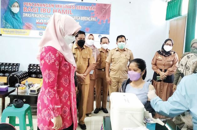 LINDUNGI IBU HAMIL: Ketua TP PKK Kota Mataram Hj Kinnastri Roliskana didampingi Kepala DP2KB Kota Mataram Hariadi memantau vaksinasi ibu hamil di Kantor DP2KB Kota Mataram, kemarin (14/9). (DP2KB FOR LOMBOK POST)