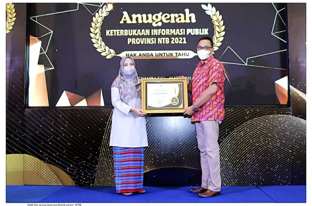 MEMBANGGAKAN: Kepala Sub Bagian Humas, Protokol dan Perjalanan Sekretariat Dewan DPRD NTB Lalu Juan Hilary (kanan) secara simbolis menerima penghargaan dari Wakil Gubernur NTB Hj Sitti Rohmi Djalilah (kiri) atas prestasi Sekretariat DPRD NTB sebagai Badan