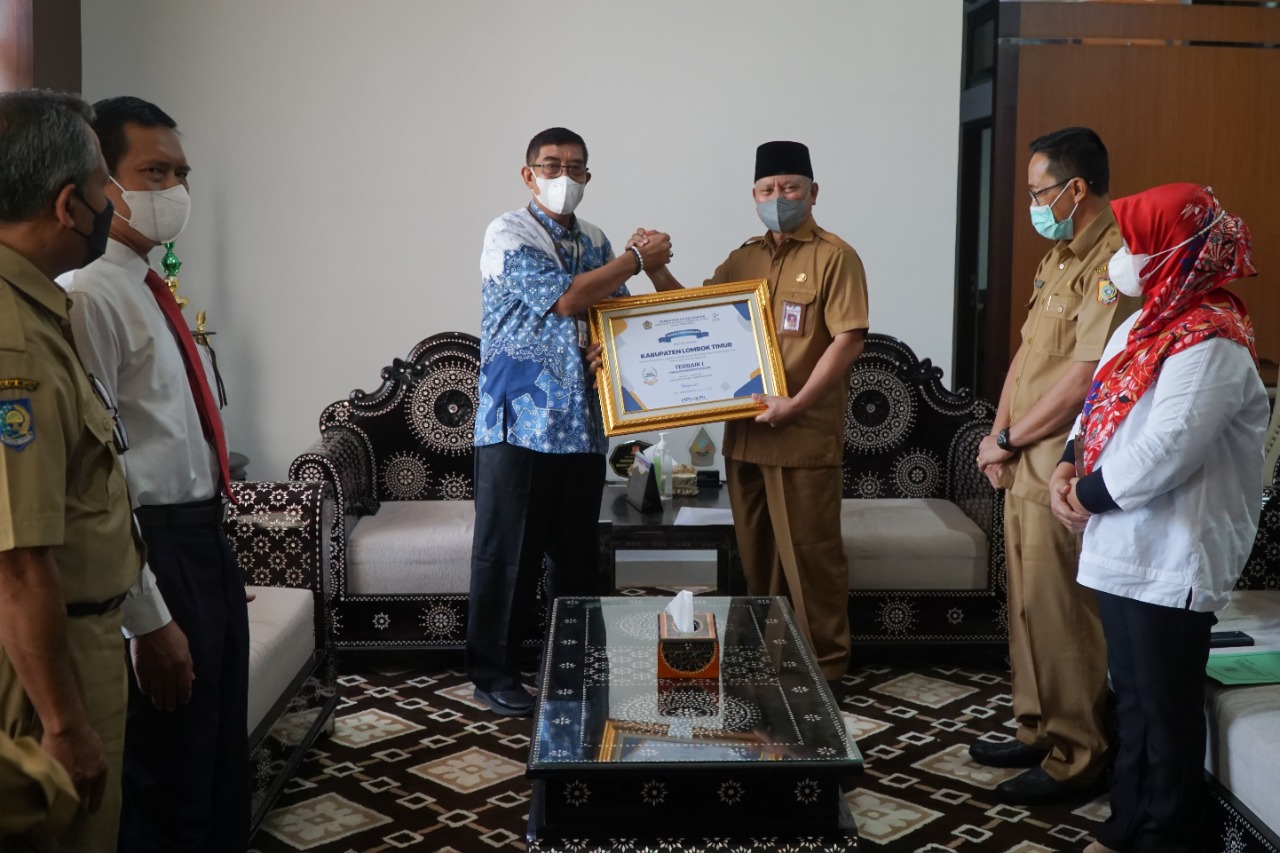 TERBAIK: Bupati Lotim HM Sukiman Azmy (kanan) menerima piagam penghargaan predikat terbaik I kinerja pengelolaan DAK Fisik dari Kementerian Keuangan RI di Pendopo Bupati Lotim, Senin (11/4). (PKP Setda Lotim for Lombok Post)