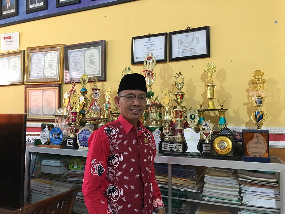 BANGGA: Kepala SMKN 2 Kuripan Rias Sandi menunjukkan prestasi para peserta didiknya, Senin (4/4). (Nila/Lombok Post)