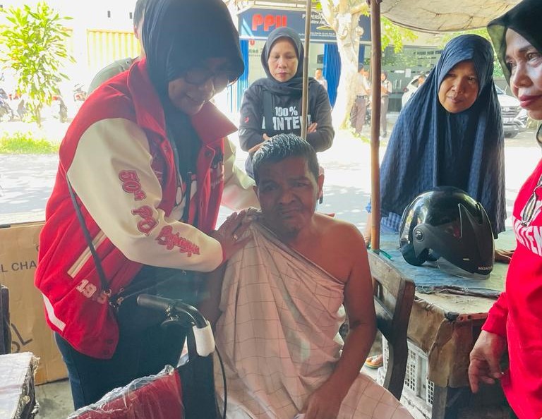 PEDULI: Politisi PDI Perjuangan Nyayu Ernawati menyerahkan bantuan kursi roda pada Asrul Sani, warga Dayan Peken, Ampenan, Kota Mataram, kemarin (22/5). (ZAD/LOMBOK POST)