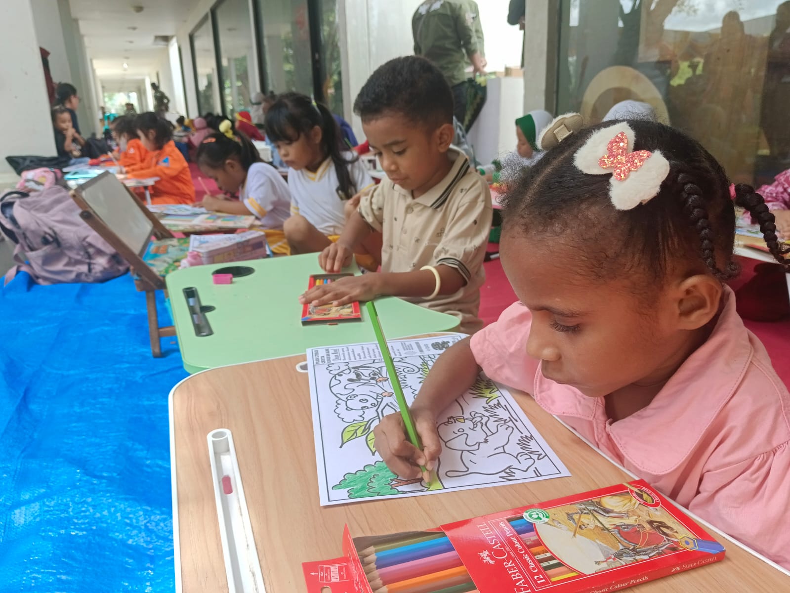 Siswa-siswi TK dan SD saat menggambar dan mewarnai yang diangkat dari cerita rakyat pada Festival Amba Mbembe di Monumen Kapsul Waktu Merauke, Kamis (15/5/2025).(CEPOSONLINE.COM/SULO).