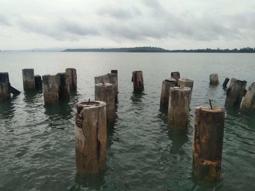 Sisa tiang pelabuhan Sarmi Kota yang berdiri di antara riak ombak laut, menjadi saksi bisu perjalanan waktu, Rabu (20/11/2025).(CEPOSONLINE.COM/VICKY AMBANI)