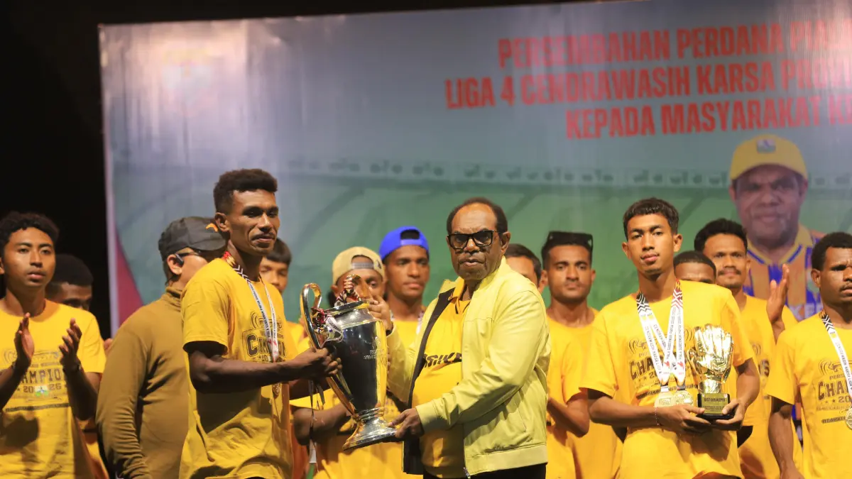 Bupati Keerom, Piter Gusbager saat menerima trophy juara dari para pemain Persiker dalam malam penyerahan trophy juara kepada masyarakat Keerom di lapangan sepakbola Swakarsa, Arso, Kamis (9/4/2026). (CEPOSONLINE.COM/ERIANTO).