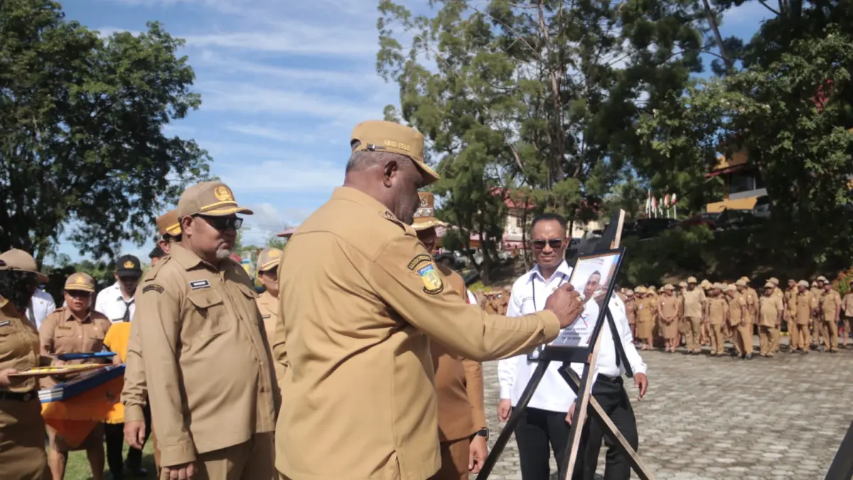 Wali Kota Jayapura, Abisai Rollo saat memberikan tanda silang merah pada foto ASN yang diberhentikan pada Apel Gabungan ASN, Senin (13/4/2026). (CEPOSONLINE.COM/HUMAS PEMKOT).