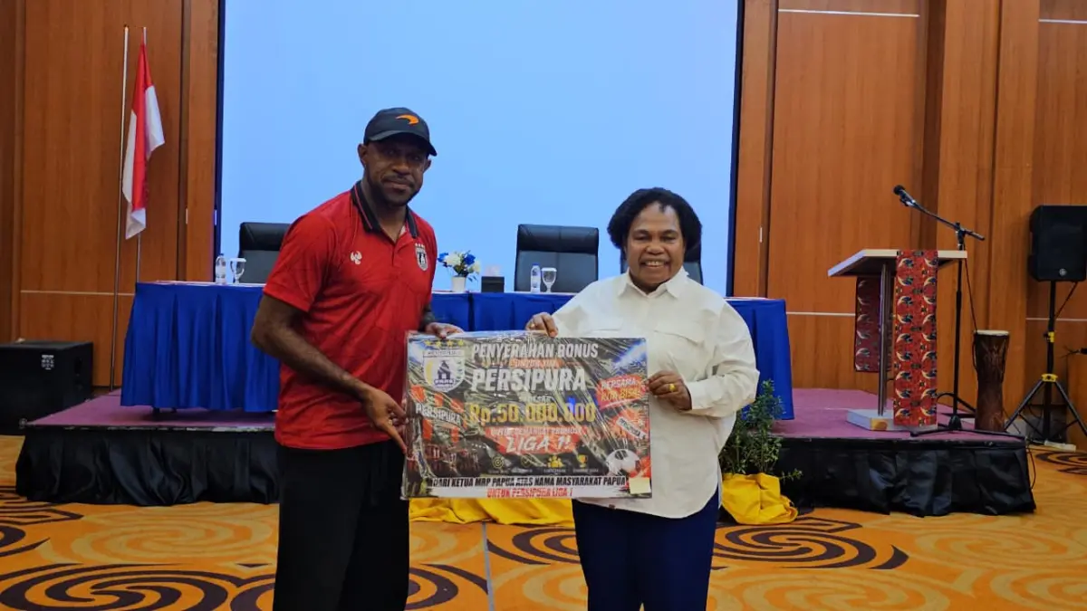 Ketua MRP Papua, Nerlince Wamuar Rollo saat memberikan bonus kepada tim Persipura diwakili Kapten Boaz Solossa. (CEPOSONLINE.COM/HANS PALEN).