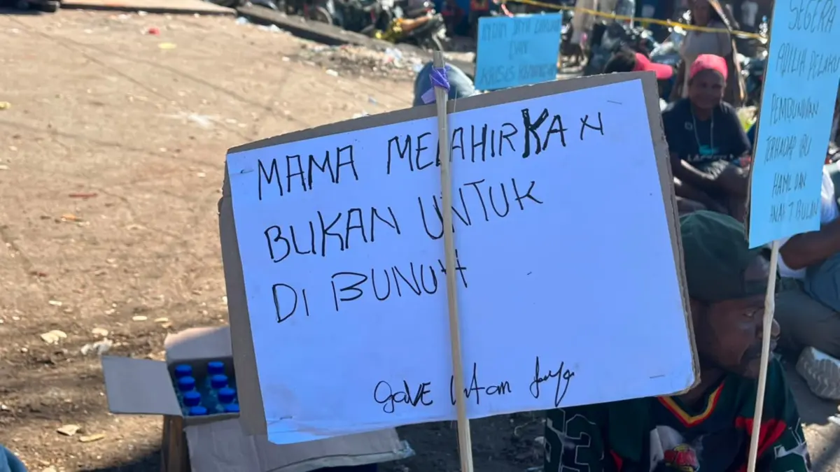 Pamflet “Mama melahirkan bukan untuk dibunuh“ yang dibentangkan dalam aksi demonstrasi di titik Pasar Karang Nabire. (CEPOSONLINE.COM/THERESIA F. TEKEGE)&nbsp;