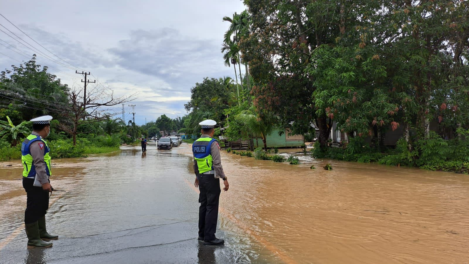 TERGENANG: Jalan Ahmad Yani, Desa Sekapuk, Satui, Kabupaten Tanbu terendam air pasca hujan deras, Kamis (11/1/2024).(foto: Polsek Satui/Radar Banjarmasin)