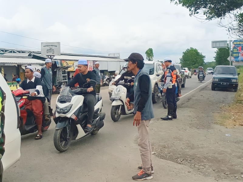 ATUR JALUR: Petugas saat mengatur arus lalu lintas jemaah haul ke-19 Guru Sekumpul, Minggu (14/1).