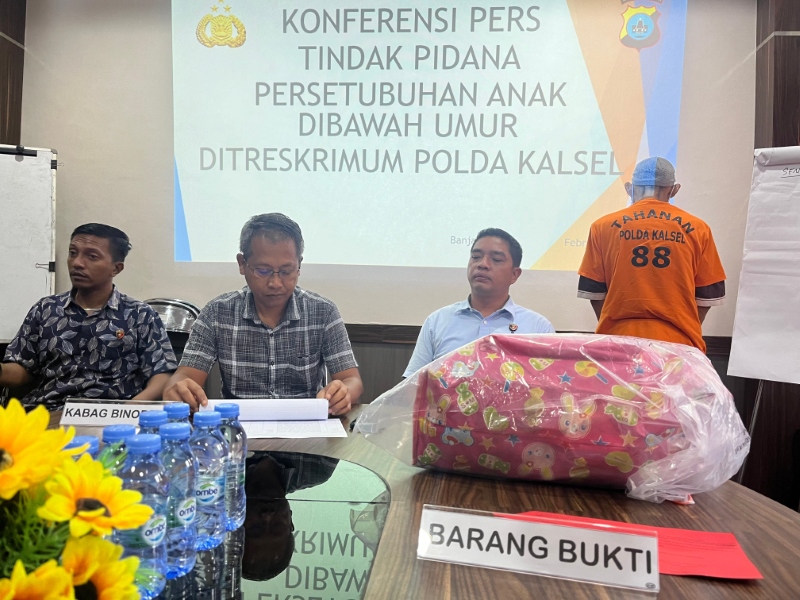 TERSANGKA: SR, 41 tahun, digiring penyidik ke Unit PPA Ditreskrimum Polda Kalsel, Kamis (1/2). SR menjadi tersangka persetubuhan anak di bawah umur. Korban adalah putri sulungnya yang masih siswi SMP.