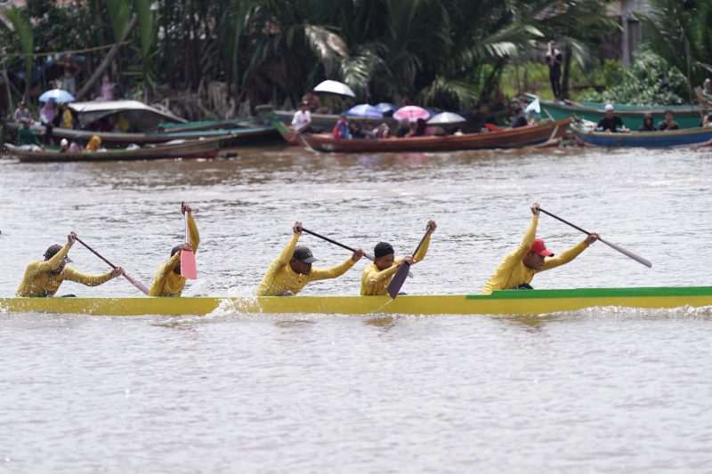 BERPACU: Aksi tim dayung Kunang-kunang saat tampil di even lomba jukung tradisonal piala Paman Birin tahun 2024 di Desa Pemurus, Kecamatan Aluh-Aluh.