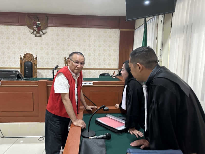 Terdakwa TPPU Narkotika, Lian Silas saat berkomunikasi dengan kuasa hukumnya. Ayah gembong narkoba, Fredy Pratama itu menyatakan menerima vonis dari Majelis Hakim PN Banjarmasin