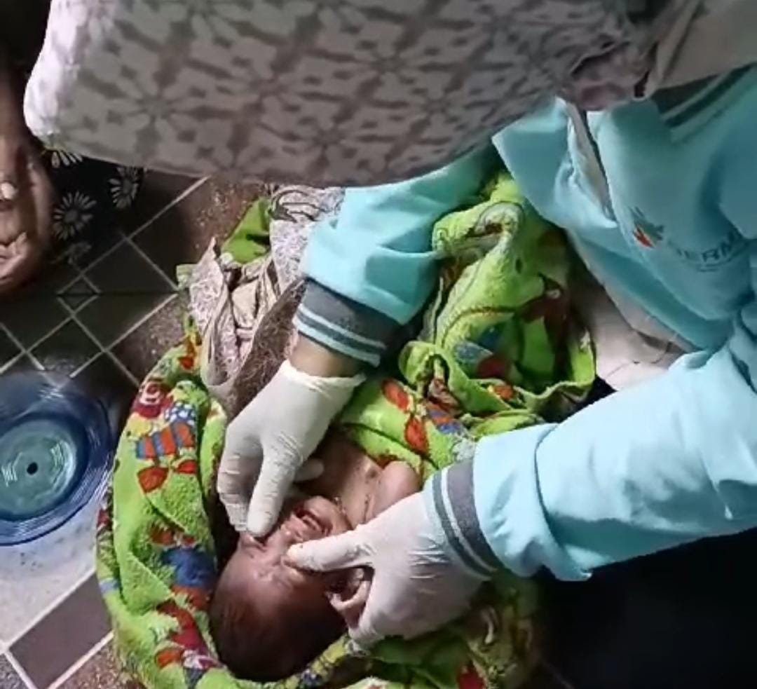 SEHAT:Bayi malang saat dimandikan bidan Desa Masingai II setelah ditemukan di semak kebun karet, Sabtu (15/6/2024).(Foto:Kades Masingai Dua For Radar Banjarmasin)