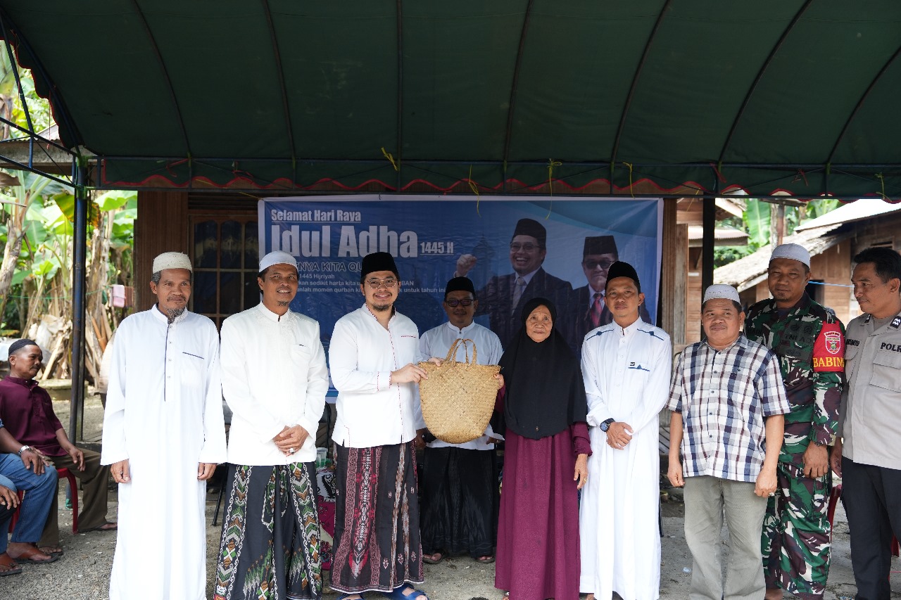 BAGIKAN: Bupati HST, H Aulia Oktafiandi membagikan daging kurban kepada warga. (Foto: Prokom HST)