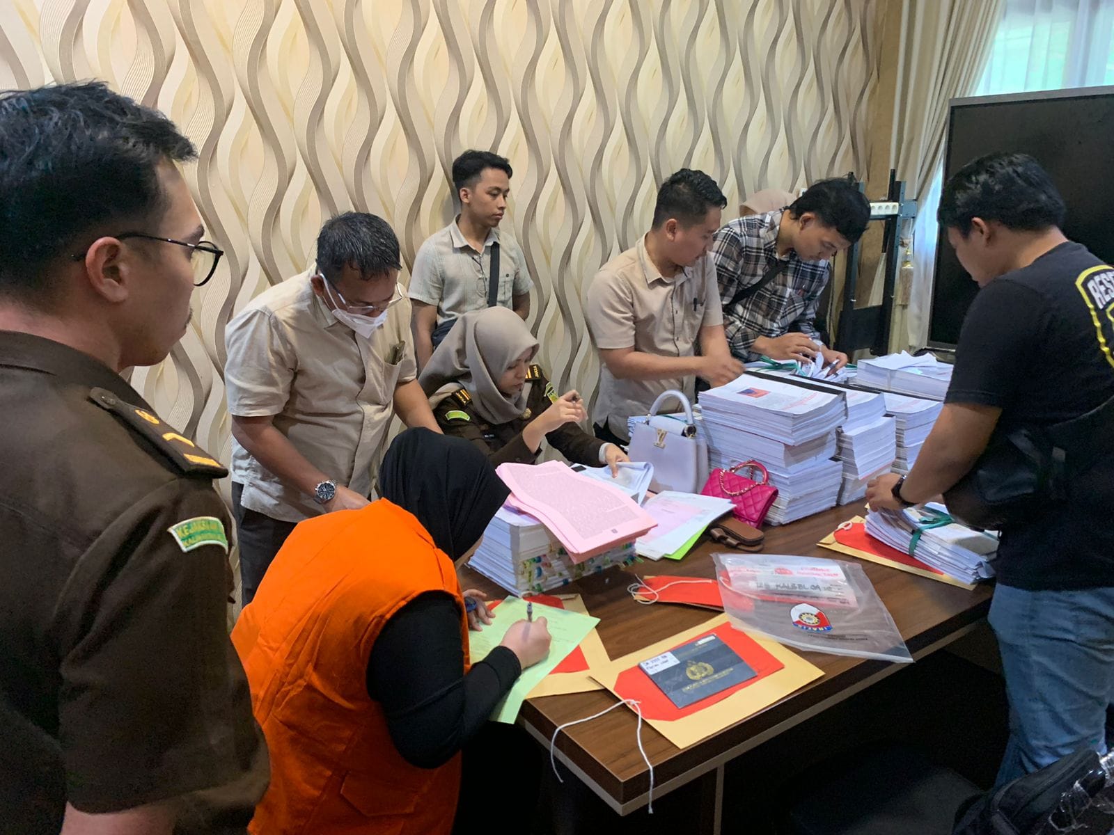 DILIMPAHKAN: Tersangka Fitriannor dengan sejumlah barang bukti kasus dugaan penipuan investasi tengah diperiksa di Ruang Tahap II Kejaksaan Negeri Banjarbaru, Kamis (20/6).