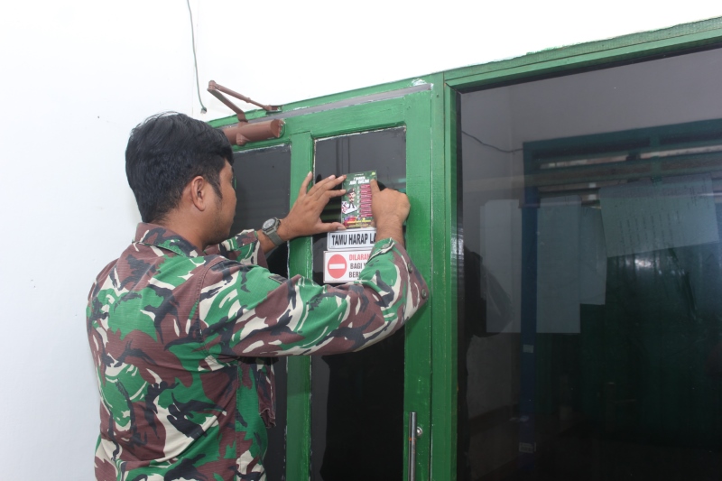TEMPEL: Personel Kodim 1001 HSU/BLG memasang sticker larangan anggota bermain judi online di rumah dinas dan markas kodim.