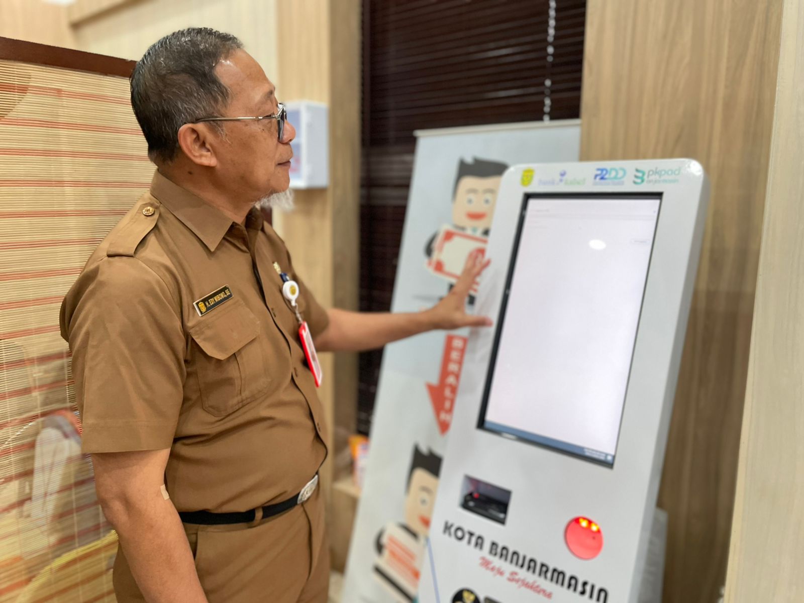 ALAT PEMBAYARAN: Kepala BPKPAD Kota Banjarmasin, Edy Wibowo menunjukkan perangkat M-Kios yang akan segera diluncurkan sebagai solusi pembayaran pajak secara praktis. Riyad Dafhi Rizki/Radar Banjarmasi