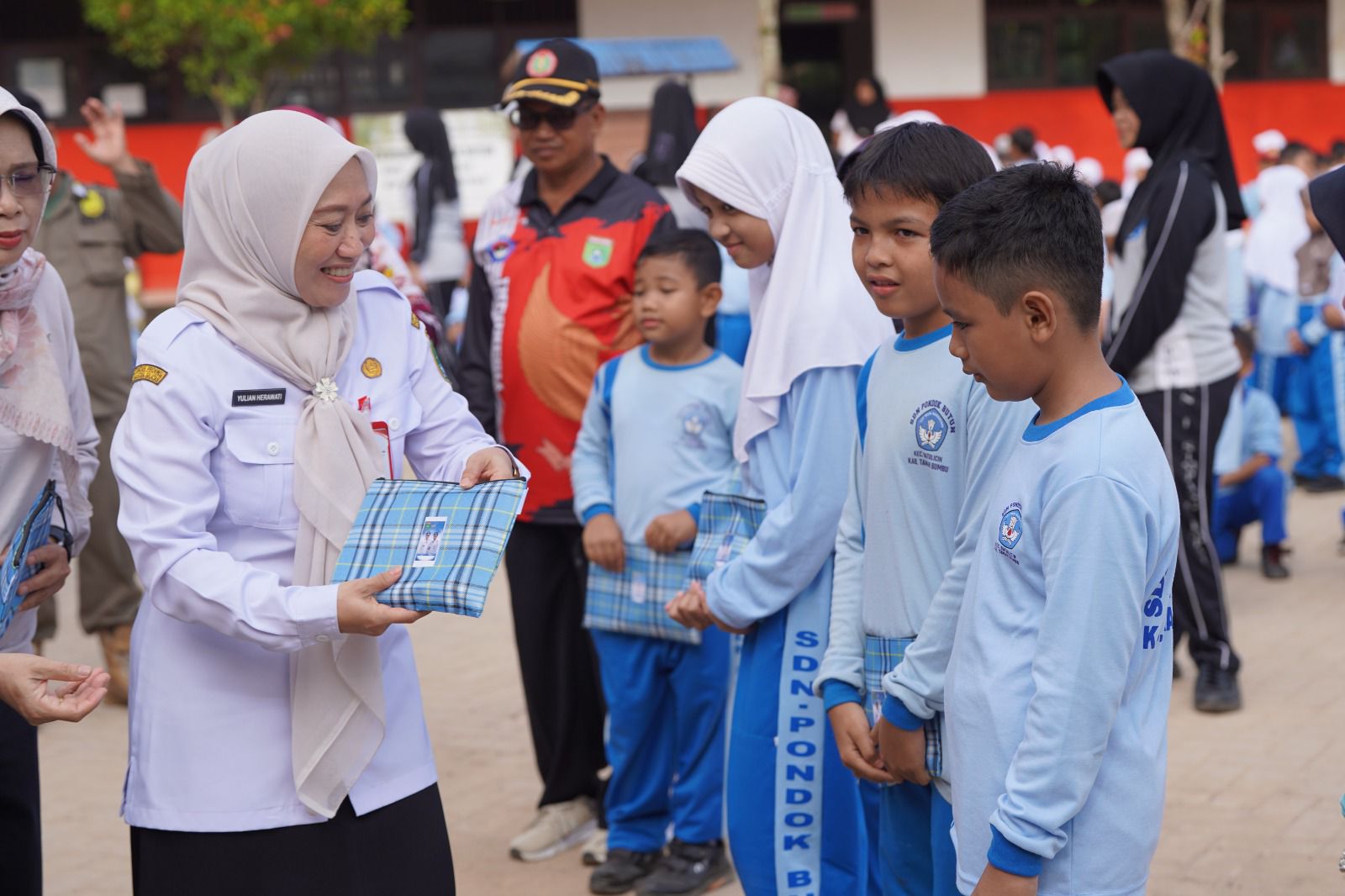 BINGKISAN: Pj Sekda Yulian Herawati menyerahkan bingkisan dari Bupati Andi Rudi Latif kepada siswa SDN Pondok Butun.