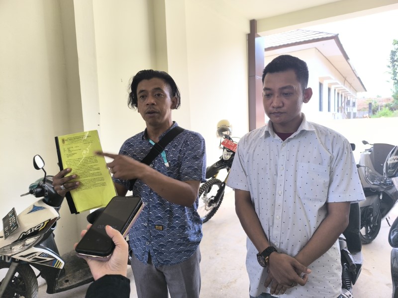 PROTES: Usan, perwakilan warga, menunjukkan dokumen tambang galian C yabg sudah beroperasi sejak 2021.  (Foto: M Dirga / Radar Banjarmasin)