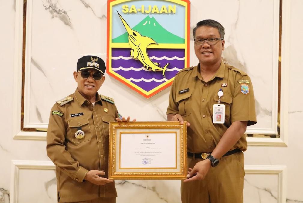 PENGHARGAAN: Bupati Kotabaru H Rusli dan Kadisparpora Kotabaru Soni Tua Halomoan memperlihatkan penghargaan dari Kemenpar RI.
