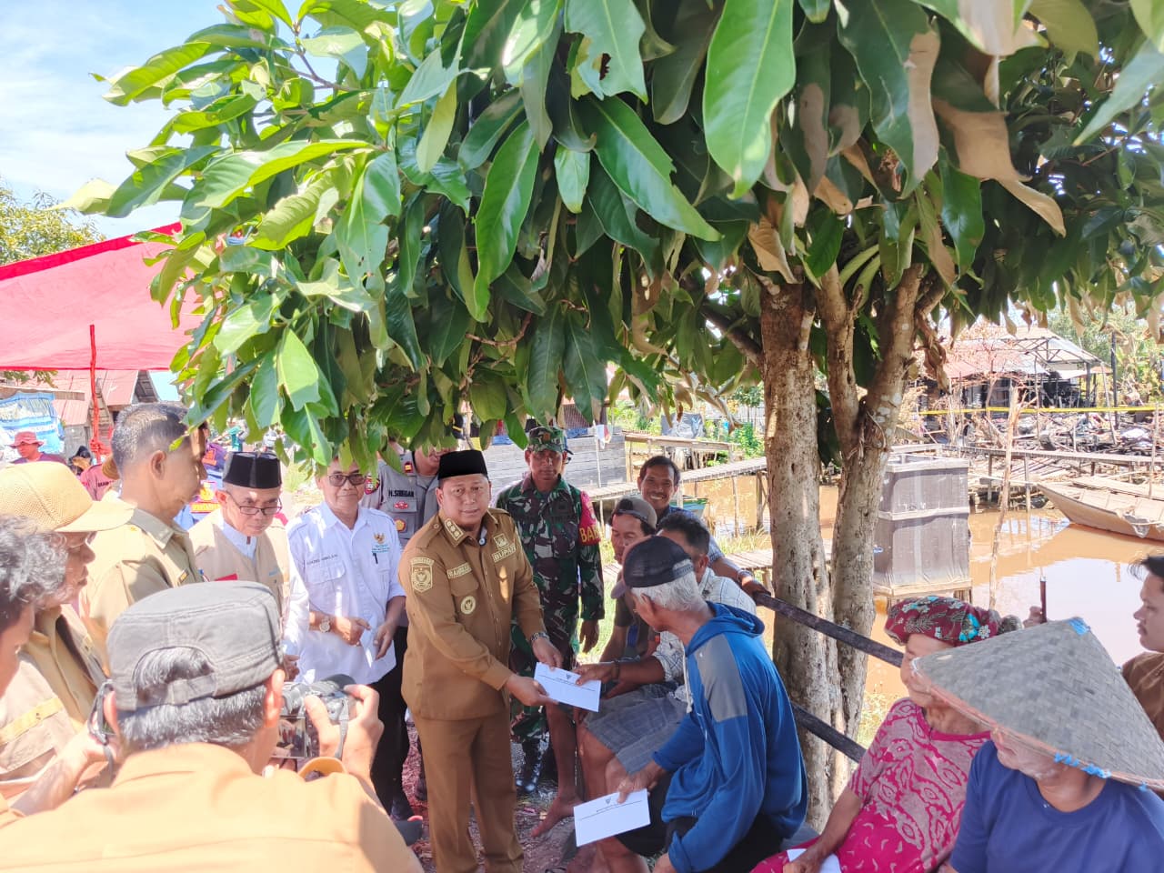 PEDULI:Bupati Batola H Bahrul Ilmi langsung menyerahkan bantuan kepada para korban kebakaran.