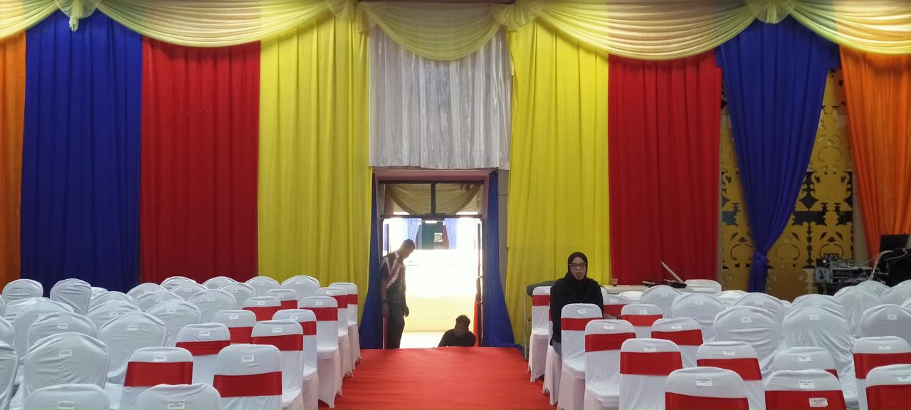 MENYIAPKAN: Dua pekerja merapikan karpet merah di ruang rapat paripurna DPRD Kota Banjarmasin.