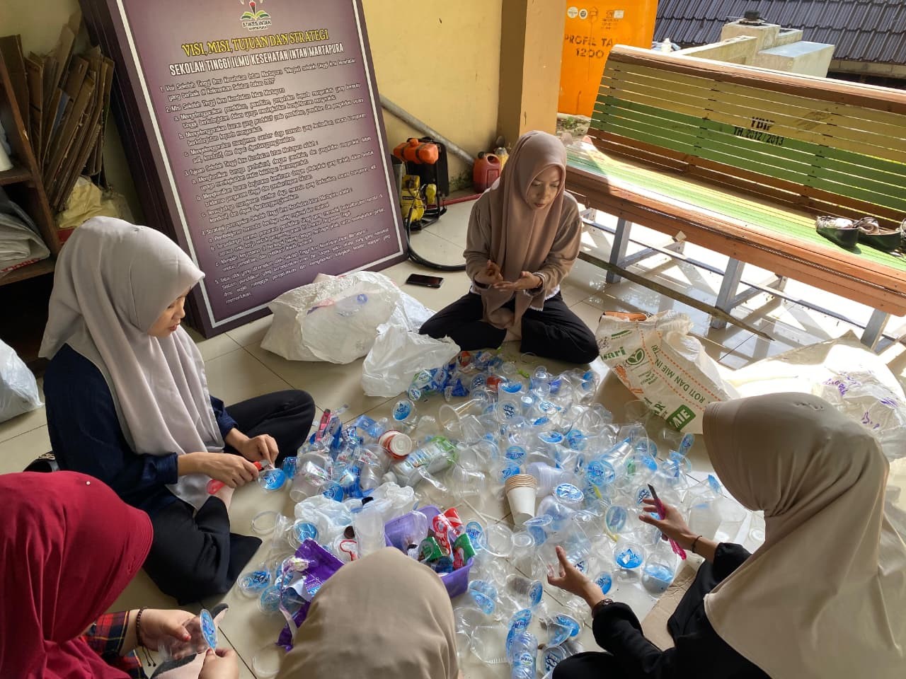 PILAH BOTOL:Mahasiswa Program Studi Administrasi Rumah Sakit (ARS) Stikes Intan Martapura memilah botol plastik bekas di area kampus dalam kegiatan rutin pengelolaan bank sampah SASAPU HIMARS.