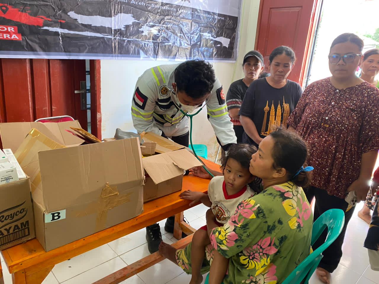 TENAGA KESEHATAN:Anggota ERT PT BIB memeriksa kondisi medis para korban bencana banjir di Batang Toru.