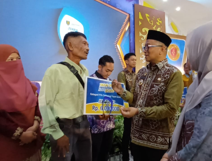 Bupati Tabalong Muhammad Noor Rifani menyerahkan hadiah penghargaan kepada inovator dalam acara Anugerah Inovasi Daerah Tabalong 2025.