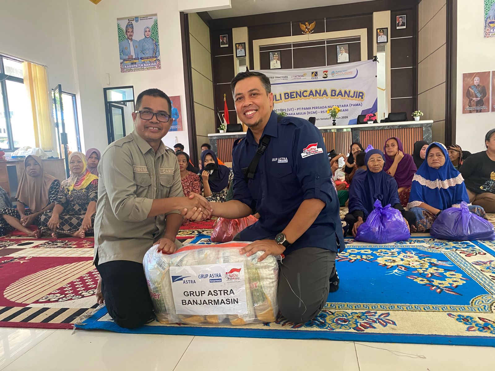 SERAHKAN BANTUAN: Ketua Bidang Penanggulangan Bencana Grup Astra Banjarmasin Arif Cahyadi menyerahkan bantuan secara simbolis kepada Camat Martapura Barat, Rabu (14/1/2026).
