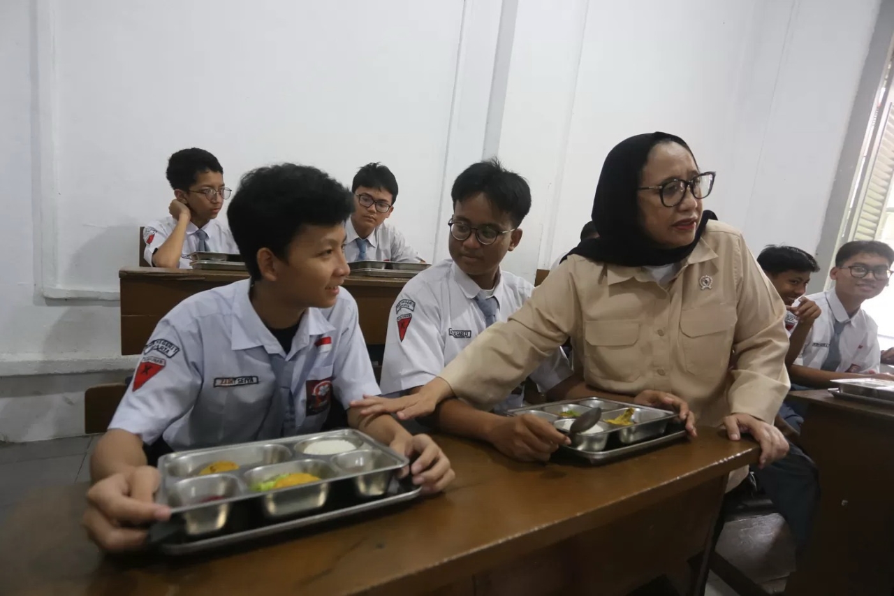 PERIKSA MAKANAN: Wakil Kepala Badan Gizi Nasional (BGN) Nanik S Deyang berbincang dengan siswa saat meninjau pelaksanaan program Makan Bergizi Gratis (MBG).