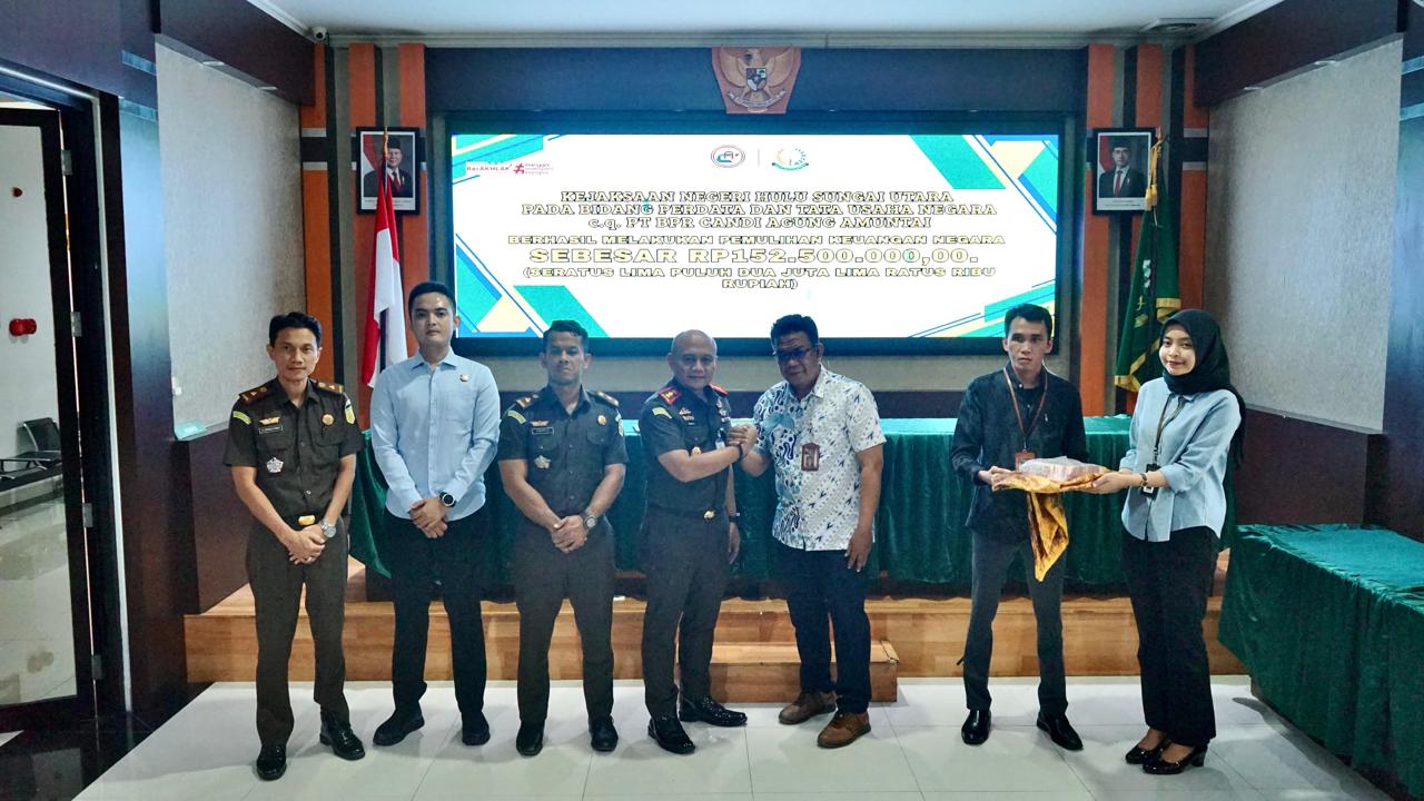 PENYERAHAN: Kajari HSU Budi didampingi Kasi Pidsus, Zaidi Fikri dan Ps Kasi Intel Andris, menyerahkan uang sitaan kredit macet ke BPR Candi Agung.