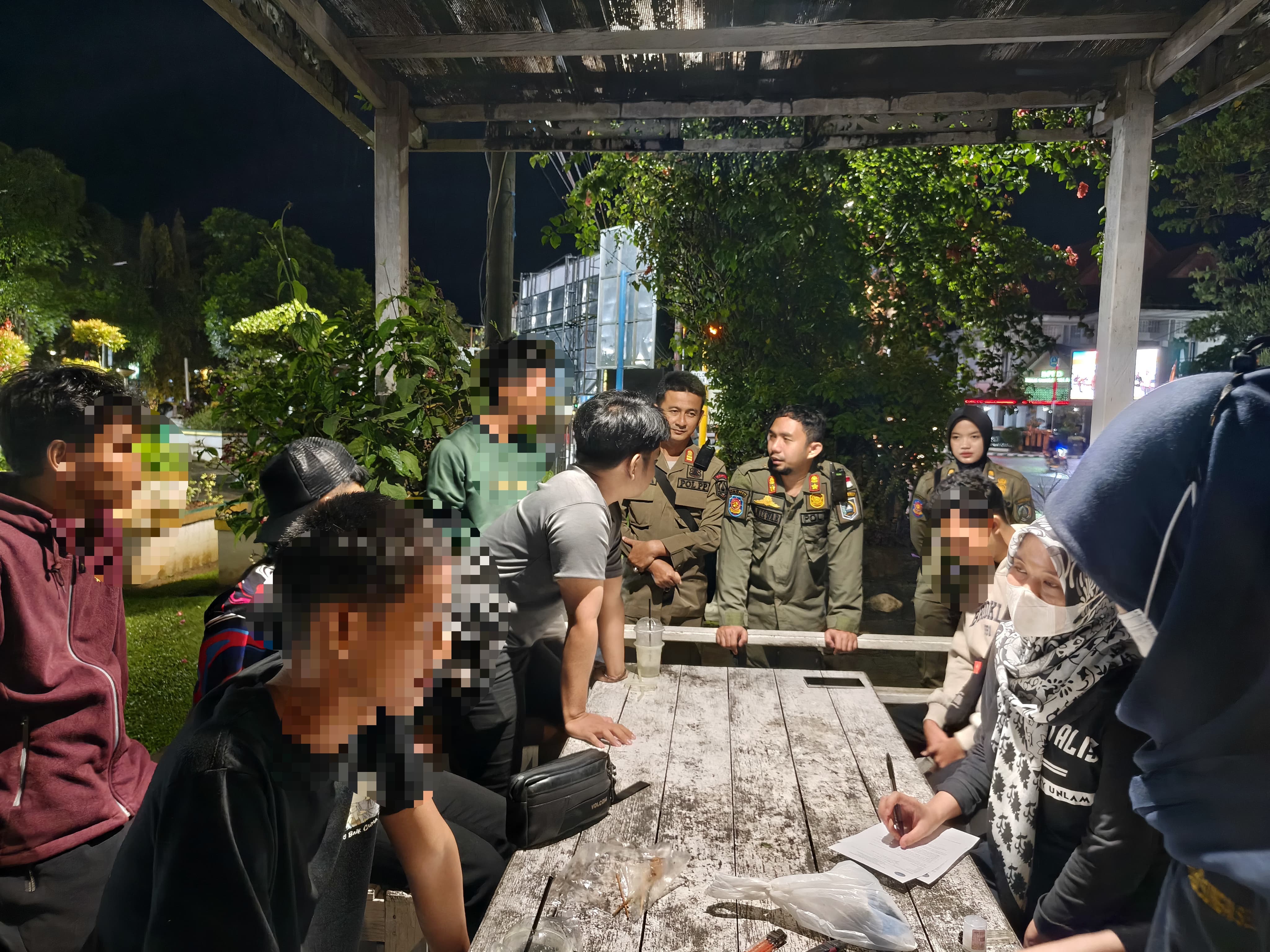 Petugas gabungan Satpol PP dan BNNK HSS mendata muda-mudi di Lapangan Lambung Mangkurat saat patroli cipta kondisi menjelang Ramadan.