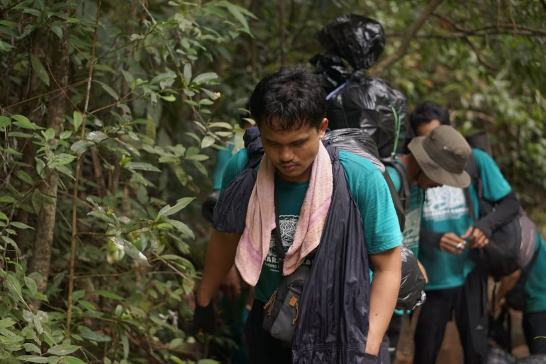 SAPU BERSIH: Anggota Pokdarwis Kahung Raya membersihkan sampah sisa logistik pendaki di kawasan Gunung Kahung, Kabupaten Banjar.