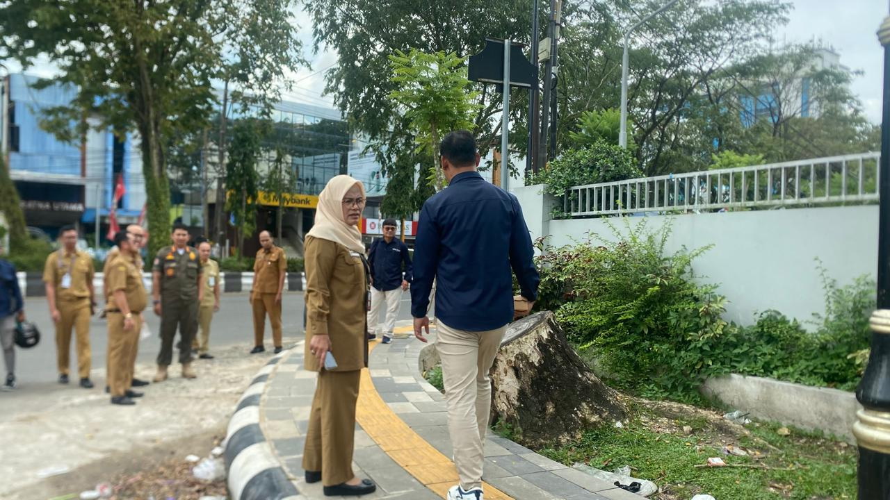 LANGKAH AWAL: Petugas Dinas PUPR bersama Diskominfotik Kota Banjarmasin melakukan peninjauan langsung terhadap kabel optik semrawut di salah satu ruas jalan, Senin (30/3).